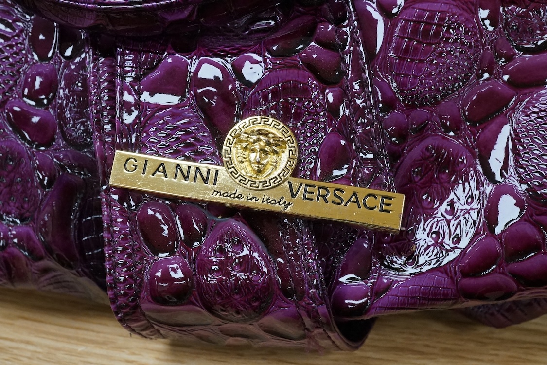 A purple patent Versace large handbag, approximately 41cm wide